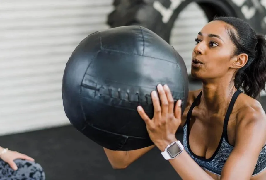 Client training with a medicine ball during a session