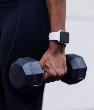 Client lifting a dumbbell during a strength session