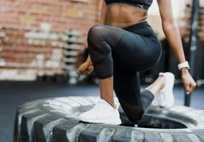 Athlete doing tire step-ups at Synergy Fitness